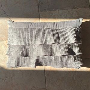 Grey decorative pillow with ruffles